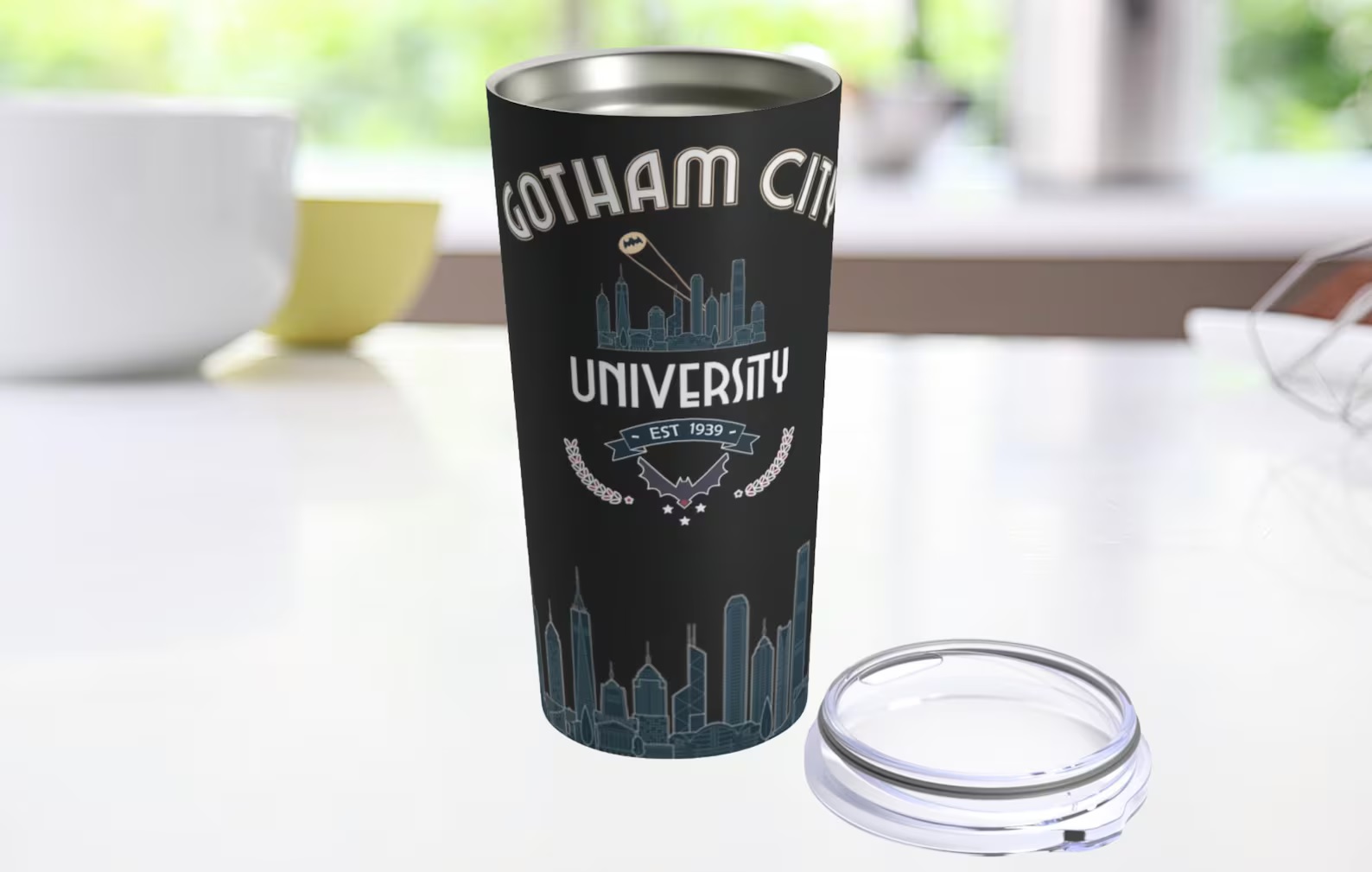 A black tumbler featuring a city skyline with a Bat-signal, plus the words "Gotham City University"