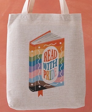 a tote bag with a graphic illustration of a rainbow colord book cover that says "Read with pride"