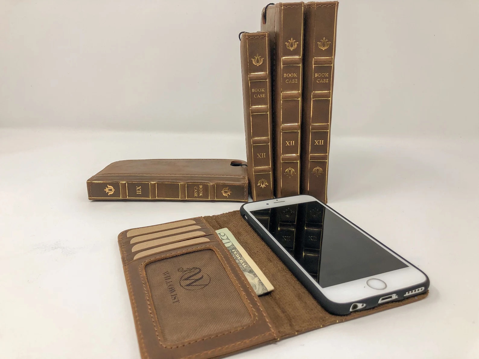 a photo of an iPhone in a leather case. the leather case is designed to look like a book.