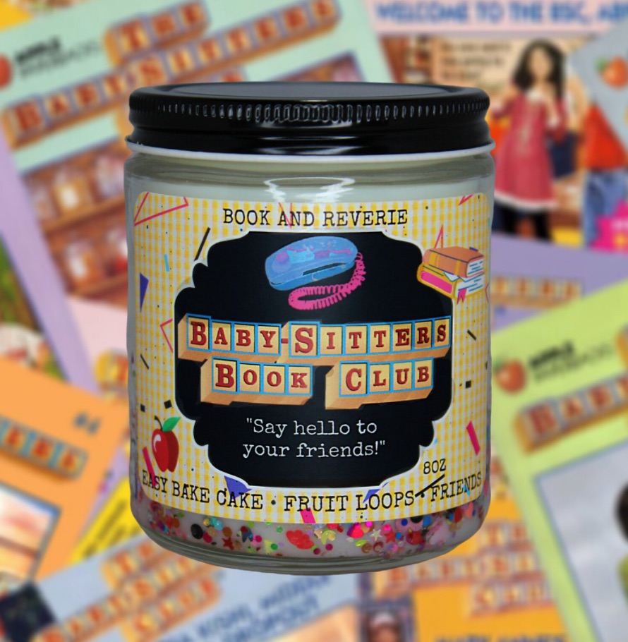 Image of a candle with a label featuring "Baby-Sitters Book Club," as phone, books, and the description of the candle's scent. 
