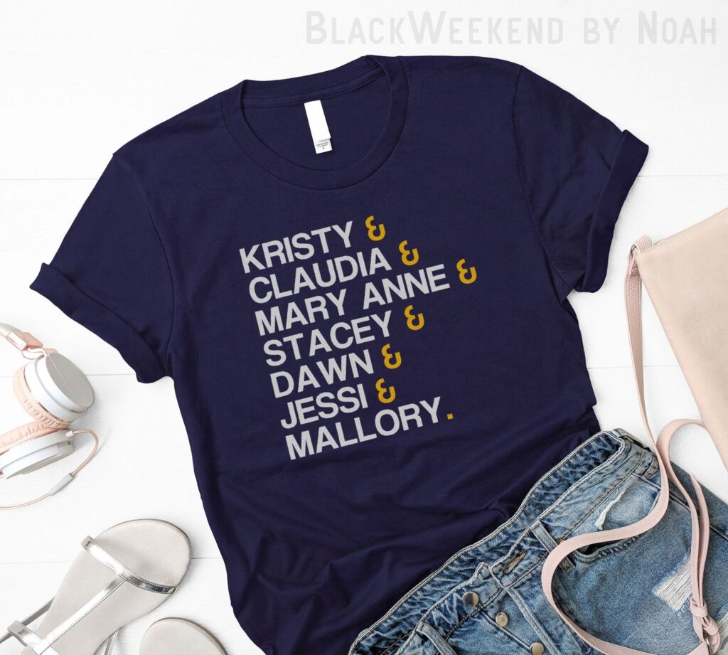 Image of a dark blue t-shirt with all of the character names on it. 
