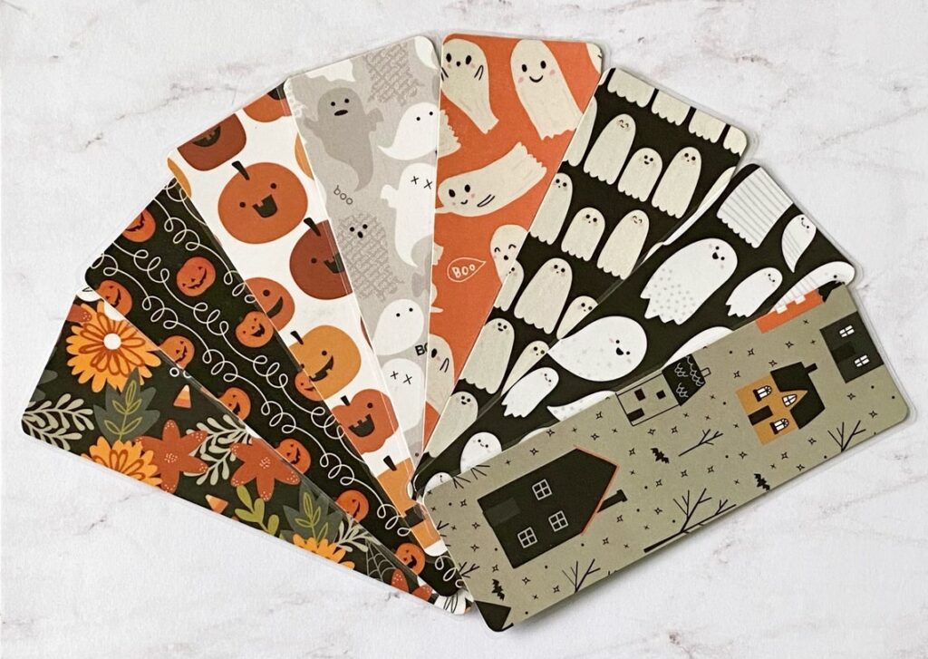 Halloween bookmarks with pumpkins ghosts flowers and haunted houses. 