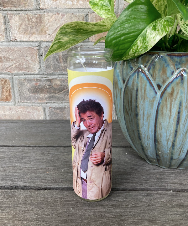 a tall glass prayer candle wrapped in an image of Columbo from the TV show