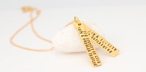 Necklace with the quote "The mystery of life isn't a problem to solve but a reality to experience."
