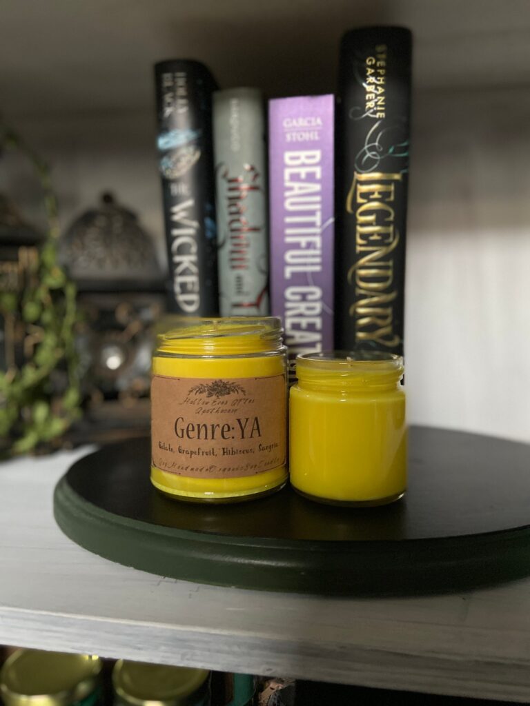 Image of a yellow candle in front of four ya books. 