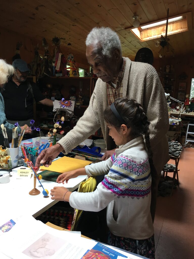 Ashley showing my daughter one of the hundreds of toys he's collected over his lifetime.