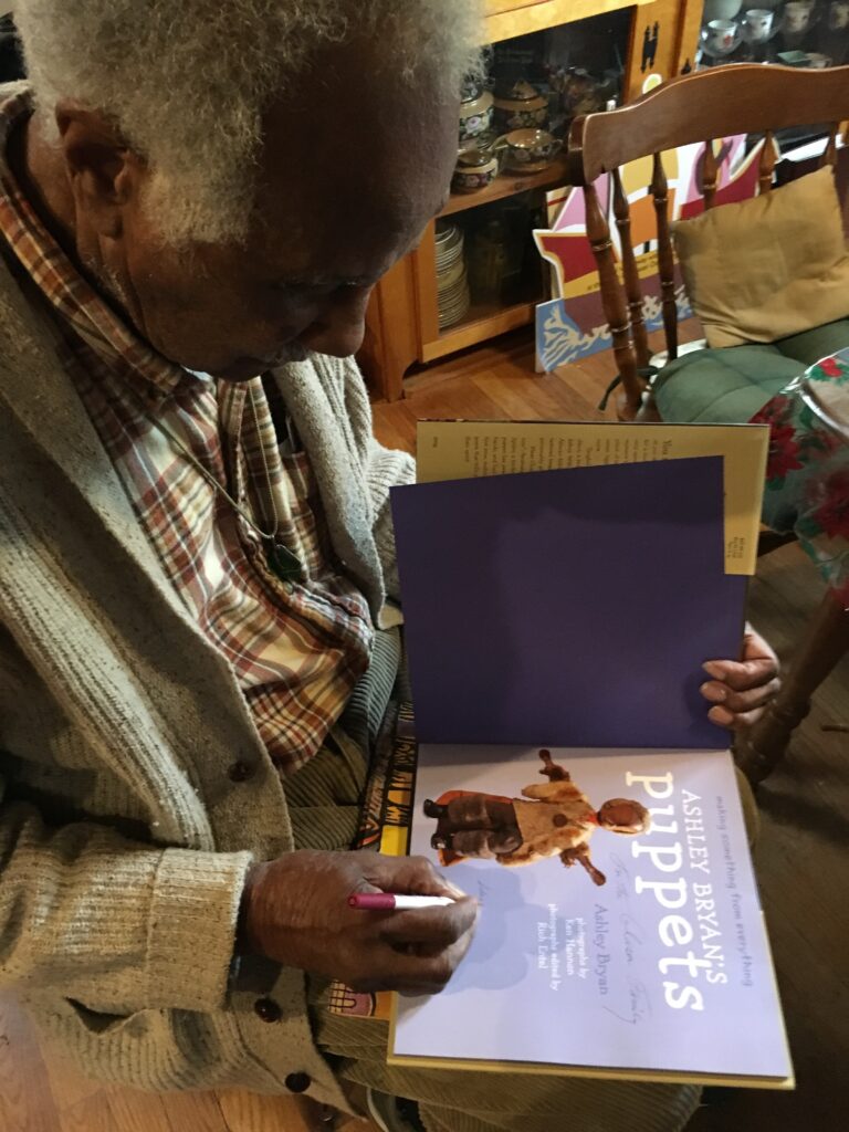 Ashley signing a copy of his book to my daughters.