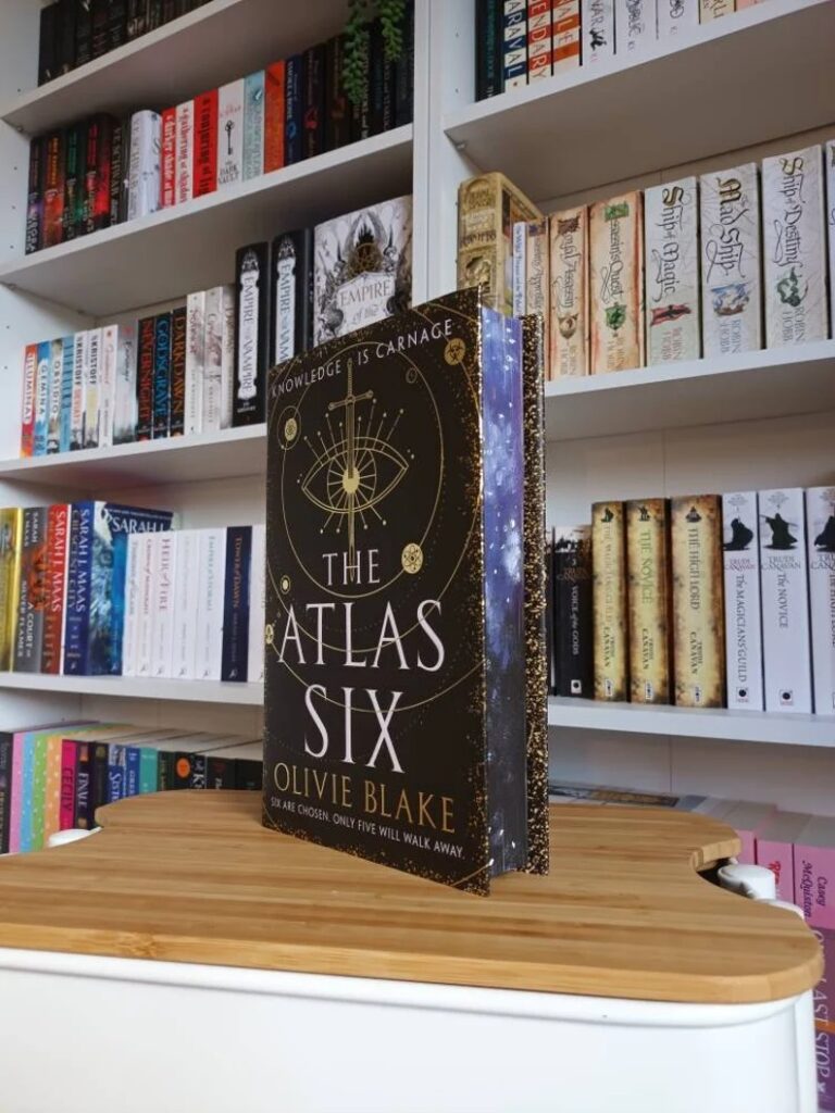 a copy of The Atlas Six with a sprayed edge design