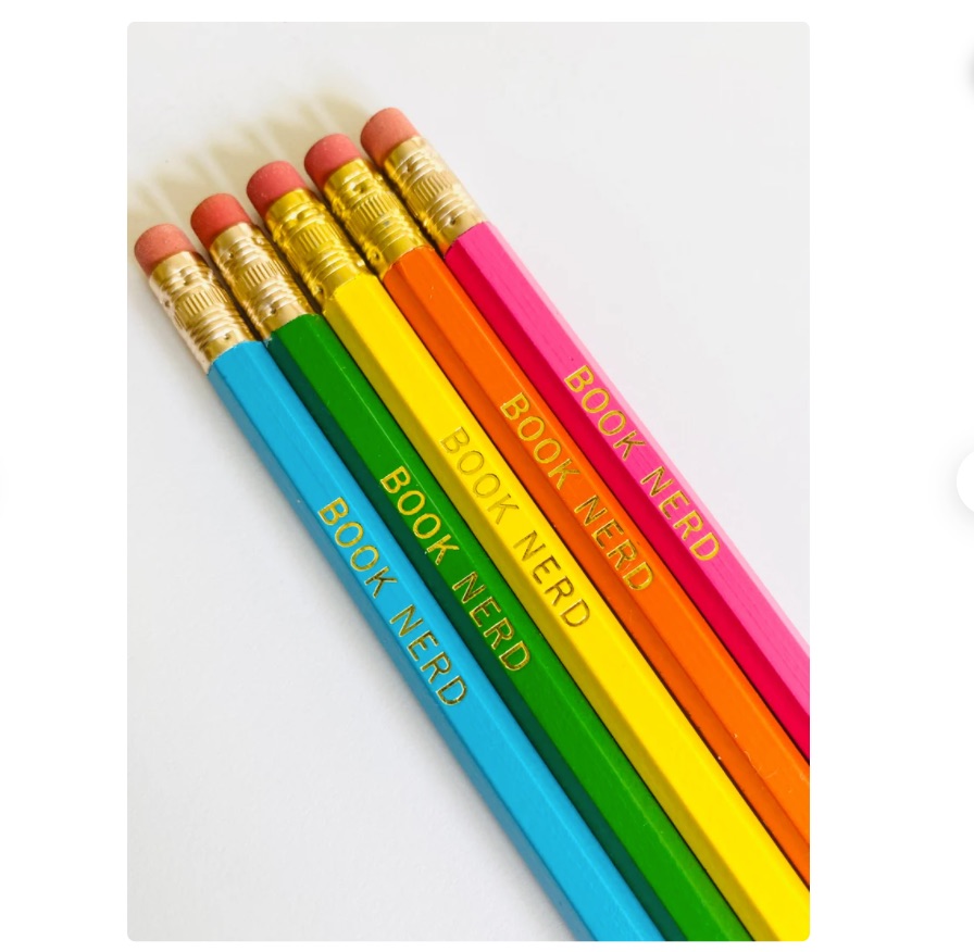 Image of five rainbow colored pencils. Each one has gold text that says "book nerd."