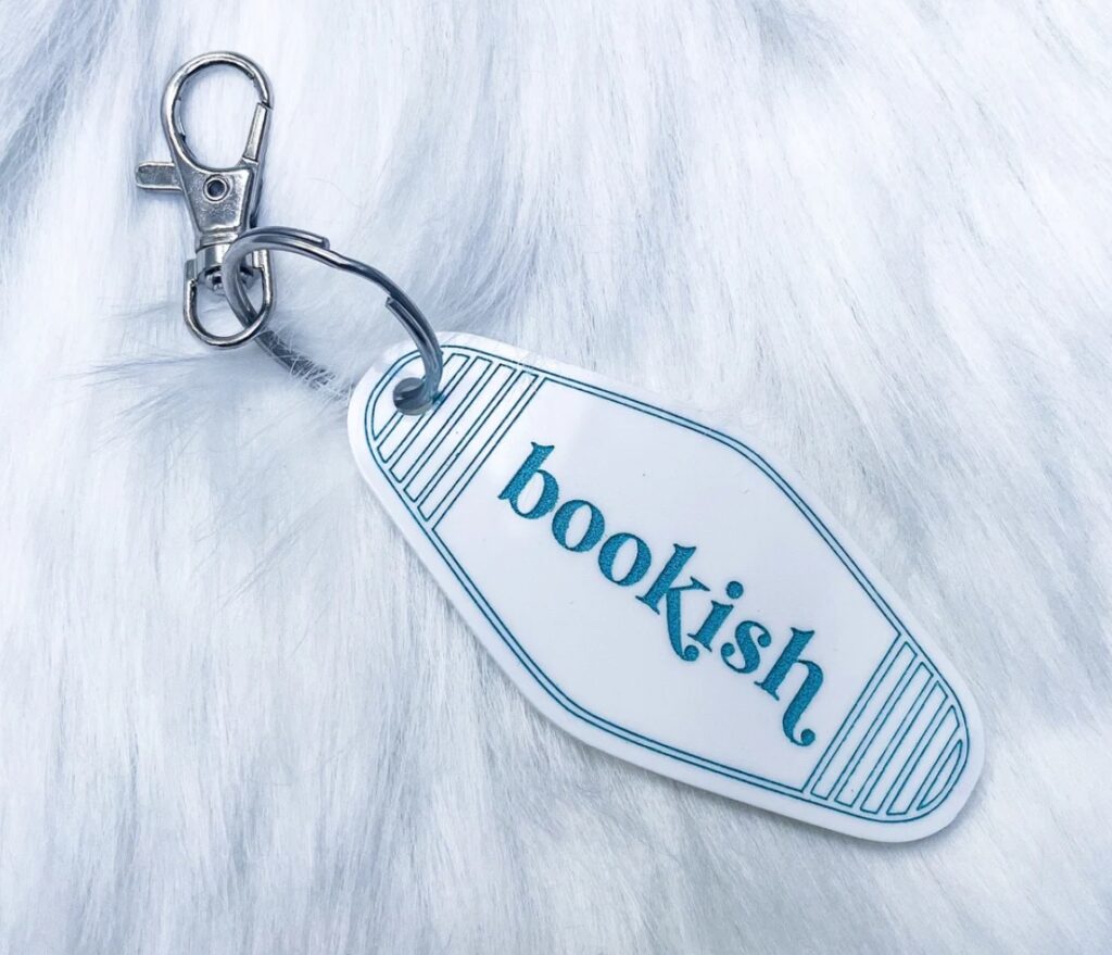 Image of a vintage hotel keychain with the word "bookish" in vintage font. 