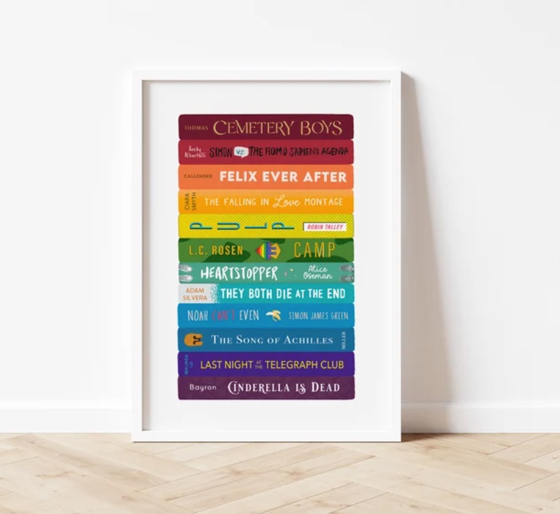 Image of a print that features a rainbow stack of queer books, primarily YA titles. 