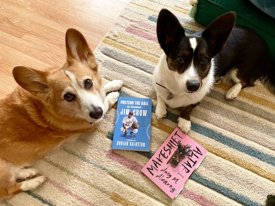 a photo of Gwen, a black and white Cardigan Welsh Corgi, and Dylan, a red and white Pembroke Welsh Corgi, sitting on a multicolored rug. In front of them are the two poetry collections, Makeshift Altar and Pretend the Ball Is Named Jim Crow.