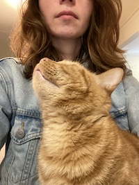 writer Emily and her orange cat Murray showing off their chins
